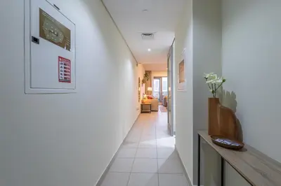 a hallway with white walls and a stairway at Boulevard 2 BR- Burj Khalifa-Dubai Mall- pool-Gym in Dubai