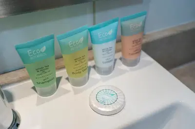 a group of four deodorants on a bathroom sink at Boulevard 2 BR- Burj Khalifa-Dubai Mall- pool-Gym in Dubai