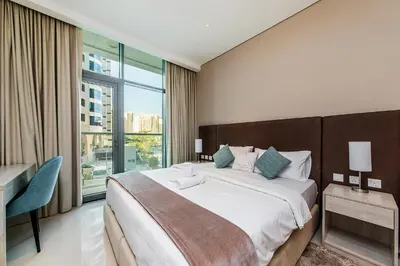 a bedroom with a large bed and a large window at Popular Seven Palm Apartments in Dubai