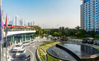 a city street with cars parked in front of a building at Popular Seven Palm Apartments in Dubai