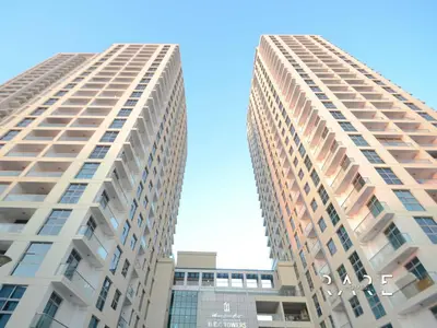 two tall apartment buildings against a blue sky at Rare Holiday Homes - Near Madame Tussauds - DEC Tower 1 - Dubai Marina - R2008 in Dubai