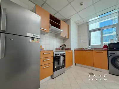 a kitchen with a stainless steel refrigerator and a dishwasher at Rare Holiday Homes - Near Madame Tussauds - DEC Tower 1 - Dubai Marina - R2008 in Dubai