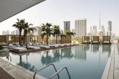 a swimming pool with a city skyline in the background at Modern Studio at Upside Living, Business Bay with Burj Khalifa View in Dubai