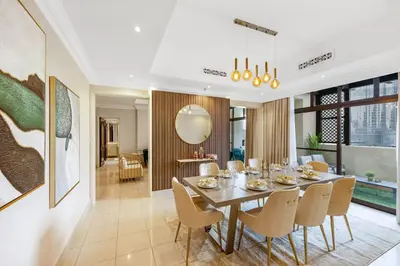 a dining room with a table and chairs at Durrani Homes - Heaven on Earth collection 4BR with panorama Burj khalifa and fountain views in Dubai