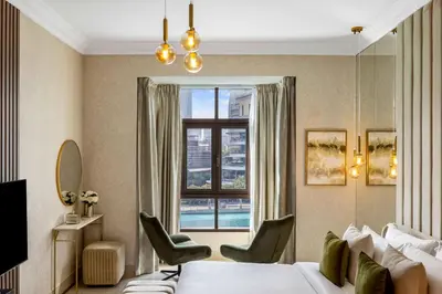 a hotel room with a bed and a window at Durrani Homes - Heaven on Earth collection 4BR with panorama Burj khalifa and fountain views in Dubai