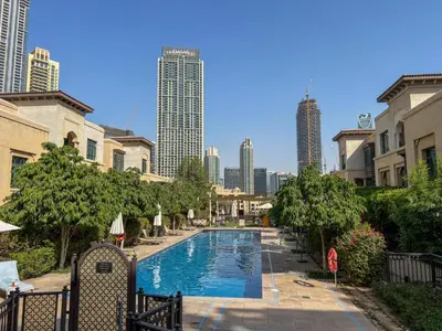 a swimming pool with a city skyline in the background at Durrani Homes - Heaven on Earth collection 4BR with panorama Burj khalifa and fountain views in Dubai