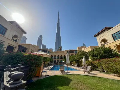 a view of a courtyard with a pool and a building at Durrani Homes - Heaven on Earth collection 4BR with panorama Burj khalifa and fountain views in Dubai