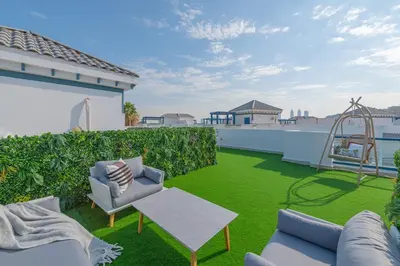 a yard with a playground on the roof of a house at Luxury Palm Villa with Beach Access -Rooftop Garden & Resort Style Pool by Exclusive Holiday Homes in Dubai