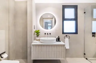 a bathroom with a sink and a mirror at Luxury Palm Villa with Beach Access -Rooftop Garden & Resort Style Pool by Exclusive Holiday Homes in Dubai