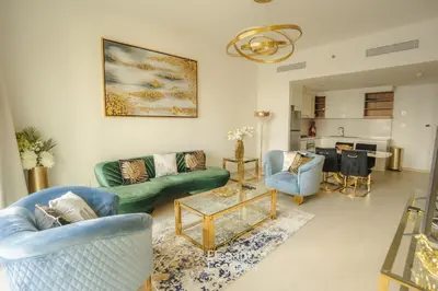 a living room with a green couch and chairs at Stylish 2 BR Apt, Amazing Fountains and Burj Views in Dubai