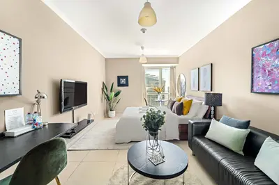 a living room with a couch and a tv at Silkhaus Modern Studio near Almas in West Lake in Dubai