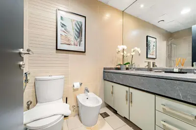 a bathroom with a toilet and a sink at Silkhaus Modern Studio near Almas in West Lake in Dubai