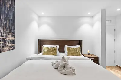 a bedroom with a bed with towels on it at Bright 3BR Apartment in JBR Close to Beach & Shops in Dubai