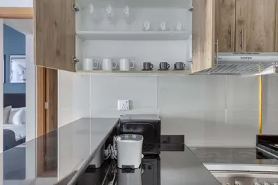 a kitchen with a counter with a coffee maker at Blueground Marina Pool Gym DXB-221 in Dubai