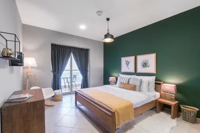 a bedroom with a large bed with a green wall at Blueground Marina Pool Gym DXB-237 in Dubai