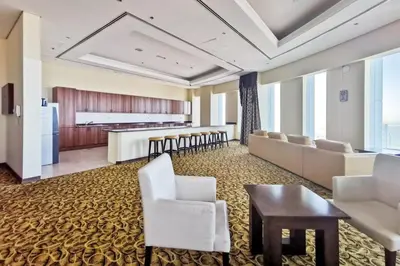 a waiting room with white chairs and a table at Blueground Marina Pool Gym DXB-237 in Dubai