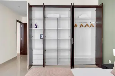 a bedroom with glass shelves and a bed at Blueground Duja Tower City View pool gym DXB-1108 in Dubai