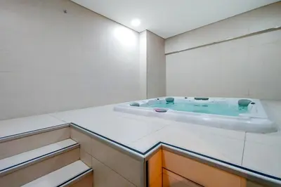 a bathroom with a jacuzzi tub in a room at Blueground Duja Tower City View pool gym DXB-1108 in Dubai