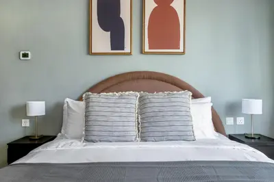 a bedroom with a bed with two lamps and two pillows at Blueground The Royal Oceanic pool gym DXB-1152 in Dubai