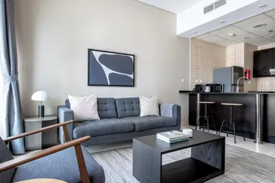 a living room with a couch and a table at Blueground The Royal Oceanic pool gym DXB-1152 in Dubai