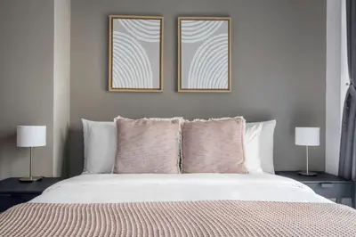 a bedroom with a bed with two pictures on the wall at Blueground Marina Gate city view sauna gym DXB-1338 in Dubai
