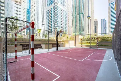 a basketball court in a city with tall buildings at Blueground Marina Gate city view sauna gym DXB-1338 in Dubai
