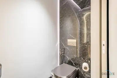 a bathroom with a toilet and a shower at Picturesque 3BR with Assistant Room in The One JBR by Deluxe Holiday Homes in Dubai