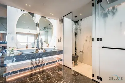 a bathroom with two sinks and two mirrors at Picturesque 3BR with Assistant Room in The One JBR by Deluxe Holiday Homes in Dubai