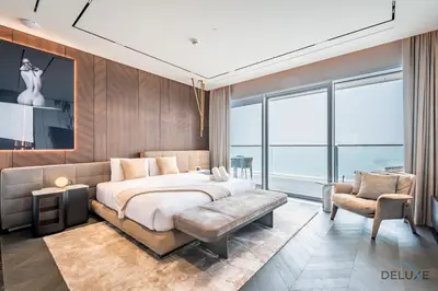 a bedroom with a bed and a couch and a chair at Picturesque 3BR with Assistant Room in The One JBR by Deluxe Holiday Homes in Dubai