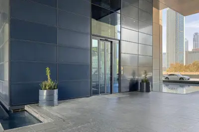 a building with two potted plants on the side of it at Blueground DIFC indoor pool fitness center DXB-1515 in Dubai