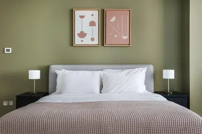 a bedroom with a bed with two pictures on the wall at Blueground DIFC indoor pool fitness center DXB-1515 in Dubai