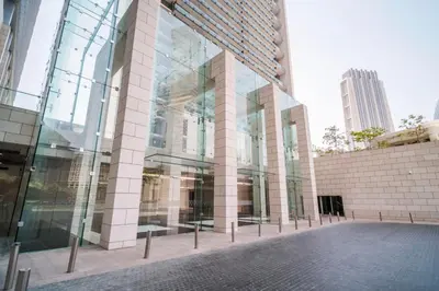 a glass facade of a building in a city at Blueground DIFC Burj K view pool fitness DXB-1535 in Dubai