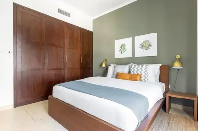 a bedroom with a large bed with wooden cabinets at Blueground Downtown B Khalifa view pool DXB-645 in Dubai