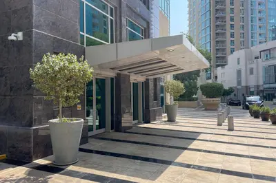 a building with potted trees on a sidewalk at Blueground Downtown B Khalifa view pool DXB-645 in Dubai