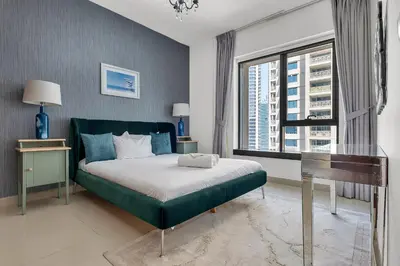 a bedroom with a bed and a desk and a window at Bellavista 1 Bedroom Full Burj Khalifa View 29 Boulevard Downtown Dubai in Dubai