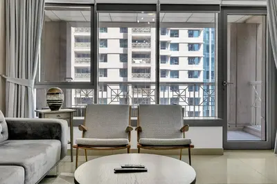 a living room with two chairs and a couch at Bellavista 1 Bedroom Full Burj Khalifa View 29 Boulevard Downtown Dubai in Dubai