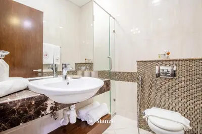 a bathroom with a sink and a toilet at Manzil - Studio in JVC w Premium Amenities near Circle Mall in Dubai
