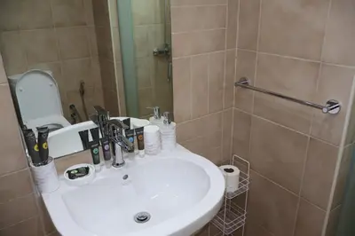 a bathroom with a sink and a shower with a mirror at Fully Furnished Garden Villa 2 Bedroom in Dubai