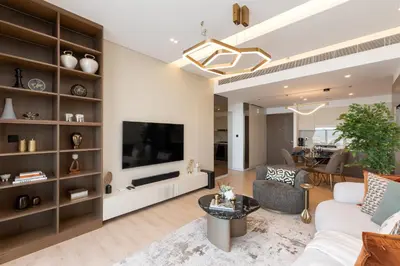 a living room with a couch and a tv at Beach Isle 2, Emaar Beachfront - Mint Stay in Dubai