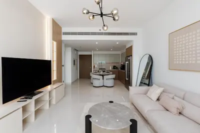 a living room with a couch and a flat screen tv at Beach Isle 2, Emaar Beachfront - Mint Stay in Dubai