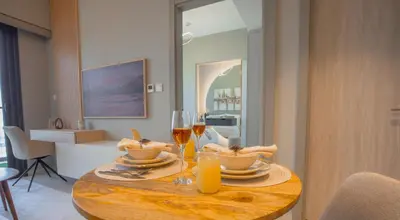 a wooden table with glasses of wine and a plate of food at Canal Vista - Home near Downtown - Awsesome views in Dubai