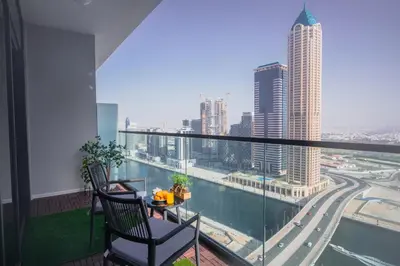 a balcony with a table and chairs and a view of a city at Canal Vista - Home near Downtown - Awsesome views in Dubai