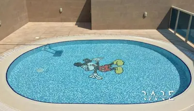a large swimming pool with a cartoon character on it at Rare Holiday Homes - Dubai Sports City - Elite Residence - R1303 in Dubai