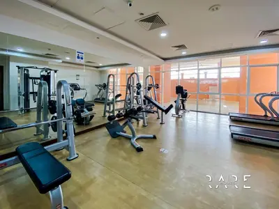 a gym with treadmills and cardio equipment in a building at Rare Holiday Homes - Jumeirah Village Circle - Near Circle Mall - Botanica Tower - R105 in Dubai