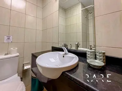 a bathroom with a sink and a toilet at Rare Holiday Homes - Near Miracle Garden - Lavender 2 - RG012 - Jumeirah Village Circle in Dubai