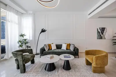 a living room with a couch and two chairs and a table at Stylish Apartment Huge Terrace Near Burj Khalifa in Dubai