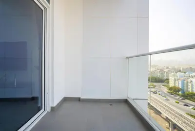 an empty room with a large window in a building at Homesgetaway -Spacious 1BR Apt in Pearlz by Danube in Dubai