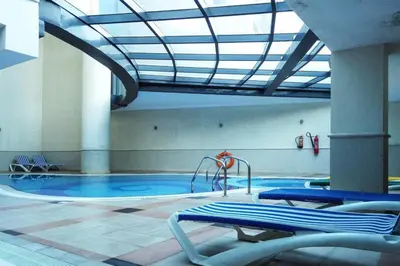 a swimming pool with a slide in a building at The Smart Concierge - Time Place in Dubai
