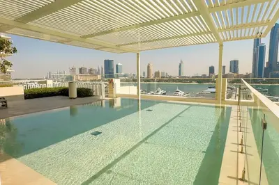 a swimming pool with a view of the city at Stunning Palm View 1BR Apartment in Dubai Harbour in Dubai