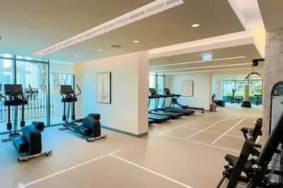 a gym with treadmills and chairs in a room at Stunning Palm View 1BR Apartment in Dubai Harbour in Dubai